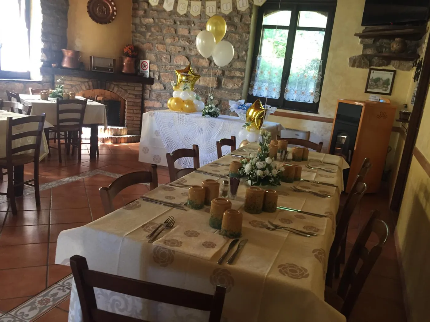 Sala del ristorante con tavoli apparecchiati e pareti in pietra